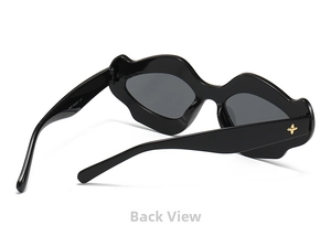 Close-up of black lip-shaped sunglasses with gold cross metal decor and dark grey lenses