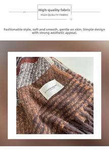 Detail shot of plaid knit scarf texture with fringe edge and brand logo tag
