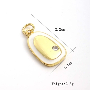 Detail view of oval gold pendant with white enamel and zircon showing 2.2cm size