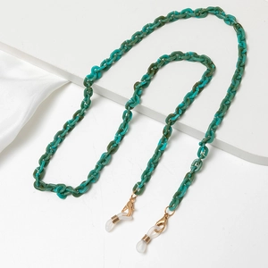 Close-up of turquoise acrylic link chain with gold lobster clasps for glasses