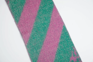 Detail shot of green and pink checkered knit scarf texture on white background