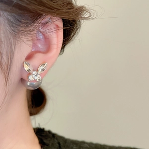 Detail of silver butterfly stud with crystal inlay and grey pearl back hanging design