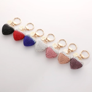 Detail of colorful heart keychains with sparkling rhinestones and golden hardware
