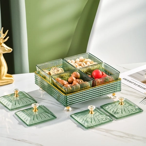 Green striped glass nut tray with four divided compartments and golden metal stand