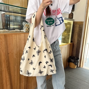 Off-white canvas tote bag with black butterfly prints for casual daily commuting and school