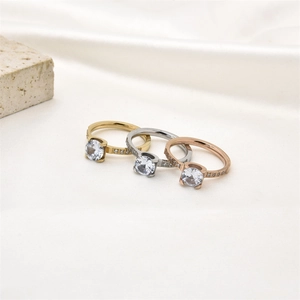 Detailed view of silver, gold, and rose gold rings with 6mm zircons on silk background