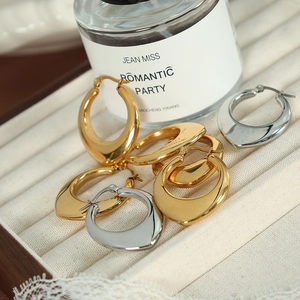 U-shaped hollow hoop earrings in gold and silver finish on a jewelry tray