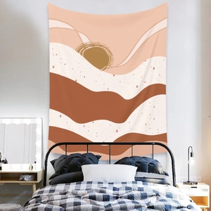 Detail of bohemian wall tapestry with abstract sun and wave design in earthy tones