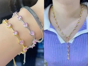 Detail of pink heart jewelry set featuring necklaces and bracelets on a female model