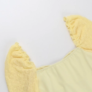 Detail of yellow floral mesh lace stitching with square neckline and puff sleeves