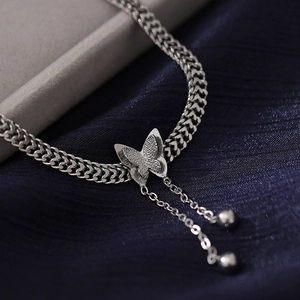 Silver Cuban chain necklace with butterfly pendant and sparkling zircon tassel detail