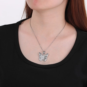 Detail of silver butterfly pendant with radiant texture and sparkling zircon stones