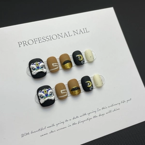 Handmade press-on nails with 3D lion dance relief and gold foil in black and caramel