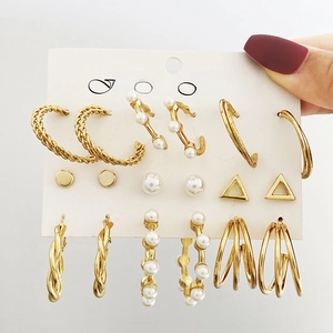 9-piece gold C-shape hoop earring set with pearls and geometric studs on display card