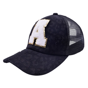 Close-up of distressed black trucker hat with sequined letter A patch and mesh back