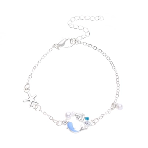 Detailed macro view of ocean-themed silver bracelet with pearls and starfish charms