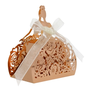 Detail of rose gold hollow candy box in bridal gown shape with white ribbon bow