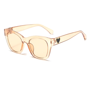 Stylish oversized square sunglasses with transparent peach frame and black heart detail.