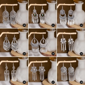 Nine vintage ethnic silver tassel earrings set with intricate cutout patterns