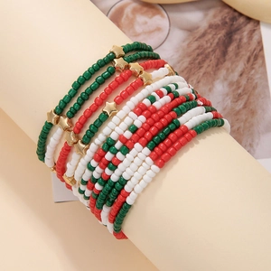 Handmade red white and green beaded bracelets set with gold star charms on a stand