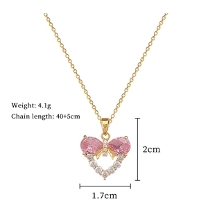 Detail view of gold necklace with pink heart pendant showing size and 4.1g weight specs