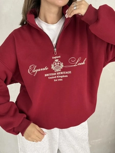 Detail of burgundy quarter-zip sweatshirt with British heritage print and polo collar