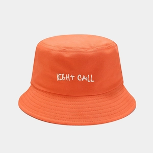 Detail of orange cotton bucket hat featuring white Night Call embroidered lettering