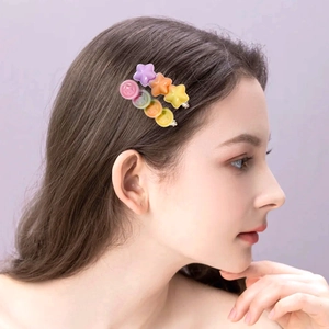 Star and round resin hair clips in candy colors shown on female model with purple hair