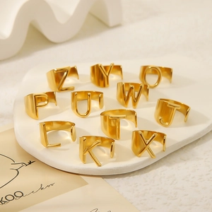 Polished 18K gold plated titanium steel alphabet open rings set for women on display