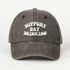 Detailed view of SUPPORT DAY DRINKING white embroidery on a charcoal washed cotton cap