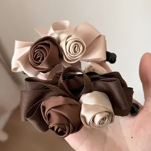 Detail of silk rose hair clip featuring elegant pearls and vintage banana clip structure
