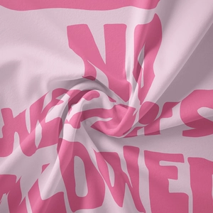 Detail of soft pink fabric featuring NO WEAPONS ALLOWED text with textured weaving