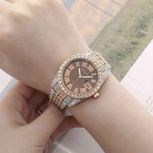 Close-up of luxury women's quartz watch with roman numerals, calendar and crystal stones
