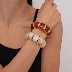 Vintage acrylic stretch bangle set in amber and marble white with gold metal accents