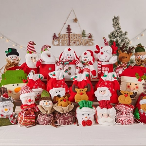 Christmas gift bags featuring Santa, snowman, and reindeer designs for holiday treats