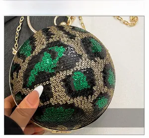 Close-up of leopard pattern sequins and gold rhinestone ring handle on the sphere evening bag
