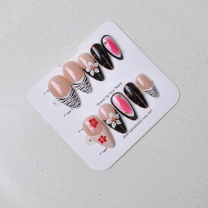 Detail of semi-handmade long teardrop press-on nails with zebra and 3D flower designs