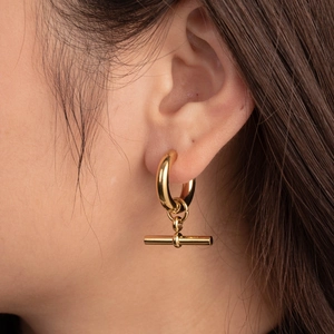 Minimalist gold hoop earrings with t-bar pendant shown on a model for a stylish look
