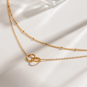 Double-layered gold stainless steel necklace with interlocking rings and bead chain