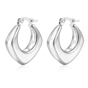 Detailed view of silver thick teardrop geometric earrings in polished stainless steel