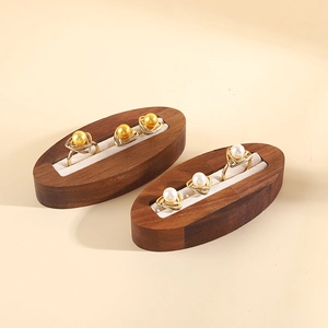 Minimalist walnut wood ring display tray with white lining and pearl jewelry