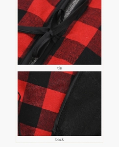 Detail of red and black checkered tree skirt featuring ties and black felt backing