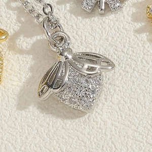 Macro shot of silver bee pendant featuring sparkling cubic zirconia pavé on an O-chain
