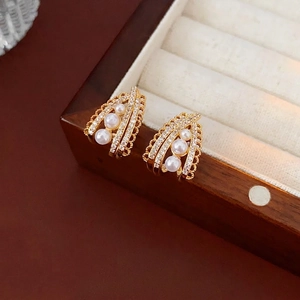 French vintage gold earrings with three pearls and zircons in a luxury jewelry box