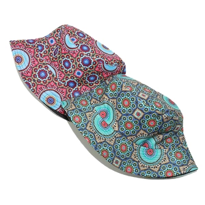 Flat lay of two bohemian bucket hats with vibrant geometric mandala patterns and wide brims
