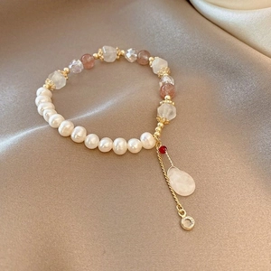 Detailed close-up of Baroque freshwater pearl bracelet with natural stones on silk