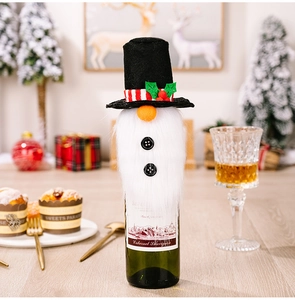 Detailed view of a gnome Christmas wine bottle cover with a black top hat and white beard