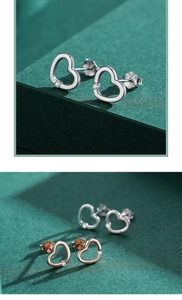 Detailed view of S925 sterling silver hollow heart earrings with small sparkling crystals