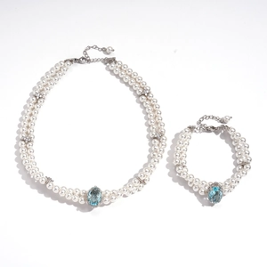 Elegant double-layered pearl jewelry set with a blue gemstone and star charms
