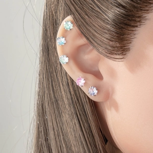 Sweet candy gradient zircon ear studs in pink and blue on a female ear cartilage